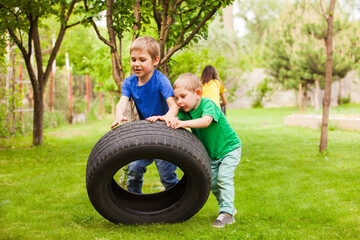 The little boys develop physical strength using improvised things