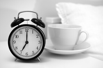 Image of coffee cup and alarm clock.   
