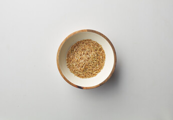 Top view shot of brown rice on white background.