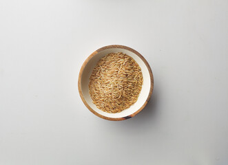 Top view shot of brown rice on white background.