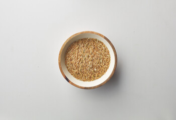 Top view shot of brown rice on white background.