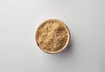 Top view shot of brown rice on white background.