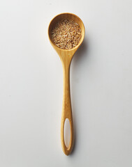 Top view shot of brown rice on white background.