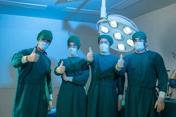 Surgeons team standing and thumbs up in the operating room before surgery.