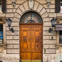 vintage residential house wooden entrance door and arched frame. Architekture in Rome, Italy