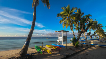kayaks on the beach and a lifeguard tower