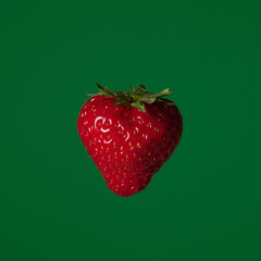 Fruit pop art red strawberry green color background art side lighting 