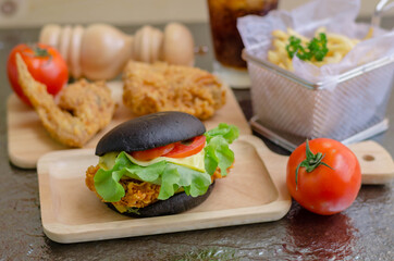 Fastfood & Junkfood concept - hamburger, fries, fries chicken and cola on metalica texture background.