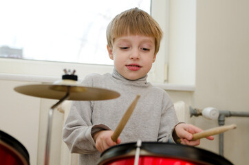 Little boy performing a drum concert early in the morning. Playing like a real Rock Star.