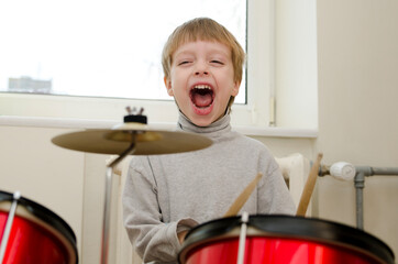 Little boy performing a drum concert early in the morning. Playing like a real Rock Star.