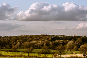 Obraz premium Landscape shot with fields, trees and clouds