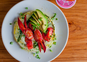 Frittata or omelette lobster avocado. Egg-based Italian dish w/ scrambled eggs, enriched with additional ingredients. classic seafood restaurant brunch/breakfast menu item. Maine lobster frittata. 