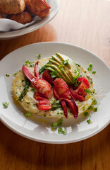 Frittata or omelette lobster avocado. Egg-based Italian dish w/ scrambled eggs, enriched with additional ingredients. classic seafood restaurant brunch/breakfast menu item. Maine lobster frittata. 