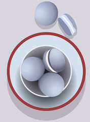 Bowl filled with blue macarons in a tray. White cream inside