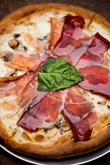 Pizza. Traditional New York City style margarita pizza pie with a thin homemade crispy crust, fresh tomato garlic marinara sauce topped with buffalo mozzarella cheese and fresh basil leaves.