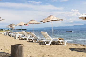 Sun beds and umbrellas by the sea.