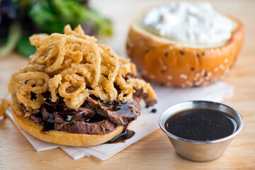 Roast Beef Sandwich. Classic Traditional american Diner sandwich. Thinly sliced roast beef topped with melted swiss cheese on top of a toasted hero roll with lettuce tomato and onion. 