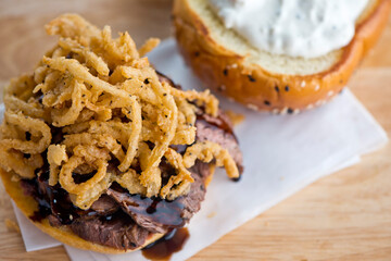 Roast Beef Sandwich. Classic Traditional american Diner sandwich. Thinly sliced roast beef topped with melted swiss cheese on top of a toasted hero roll with lettuce tomato and onion. 