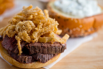 Roast Beef Sandwich. Classic Traditional american Diner sandwich. Thinly sliced roast beef topped with melted swiss cheese on top of a toasted hero roll with lettuce tomato and onion. 
