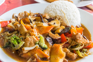 Chinese dish with pork meat, mushrooms, rice and vegetables