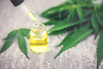 Cannabis essential oil in a small bottle. Selective focus.