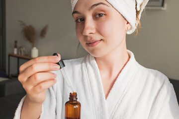 Fototapeta premium Young woman going to apply skincare product