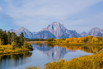 The Grand Teton at autumn time, with a reflection in the snake river.
