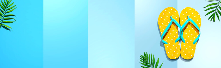 Flip flops with palm leaves- flat lay