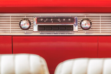 Old car radio inside a classic American car with chrome dashboard