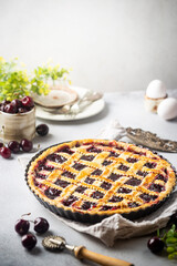 Delicious homemade classic cherry pie with a flaky crust on white background