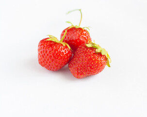 Three ripe strawberries isolated on a white background