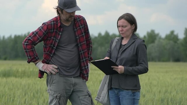 Mortgage loan officer assisting farmer in financial allowance application process