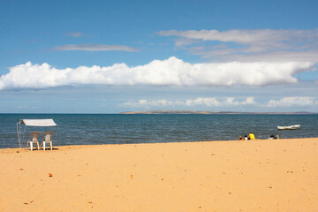 Fototapeta na wymiar Sunny day on a beach with caribbean clouds.