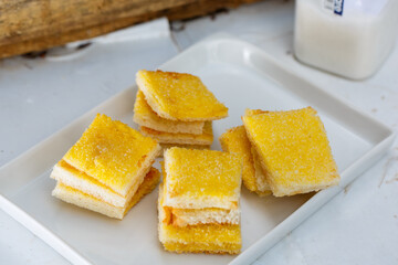 sliced toast bread with butter and sugar