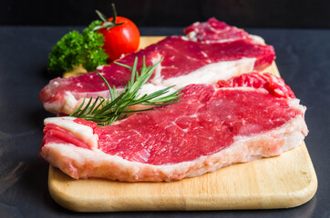 Fototapeta na wymiar Fresh rare striploin beef portion on wood bord
