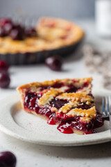 piece of Delicious homemade classic cherry pie with a flaky crust on white background