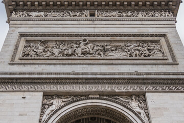 Architectural fragment of Arc de Triomphe. Arc de Triomphe de l'Etoile on Charles de Gaulle Place is one of the most famous monuments in Paris. France.