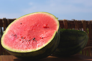 Fresh ripe sliced watermelon , on wooden background