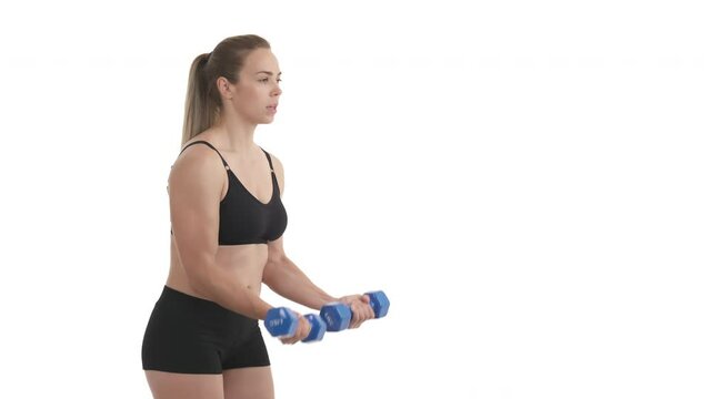 side view portrait of sportswoman’s biceps muscle training with dumbbells. Isolated on white background.
