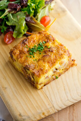 Omelette made with bacon, ham, sausage, bell peppers, heirloom tomatoes, spinach, onions, cheddar & Swiss cheese. Served with crispy potato hash, a classic American breakfast or brunch favorite.