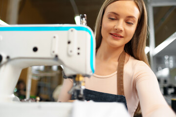 Portrait of seamstress working with sewing machine