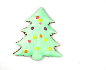 Christmas homemade gingerbread cookies on a white background. Sweet colored gingerbread cookies, place for text. Christmas tree. Isolate Banner. Copyspace