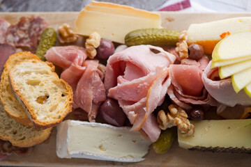 Charcuterie platter. Assortment on cured and salted deli meats and cheeses, pastrami, salami, prosciutto served with olives and dried fruits. Classic traditional party favorite.  