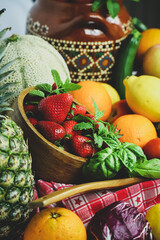 full frame of a rustic composition of fruit and vegetables arranged on a table