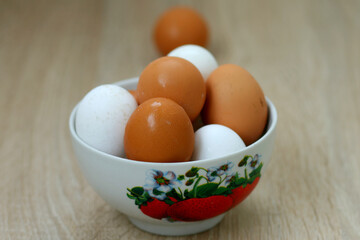 Raw chicken eggs in white and red color