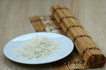 White rice grains for making sushi on a white plate