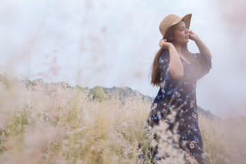 Soft focus of the Girl in a blue dress on a wheat field. woman in meadow concept