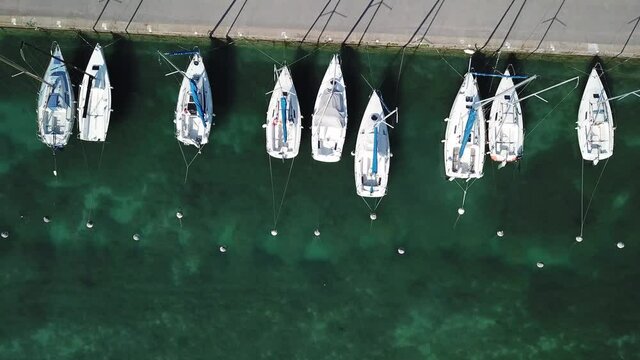 boats zoom out aerial landscape of Annecy lake, Alps, France, yachts and sailing boats from above