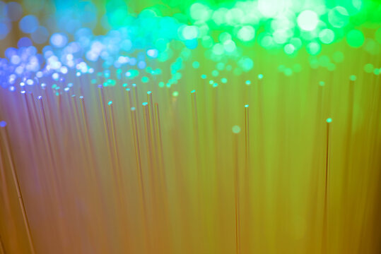 Glowing abstract multi color optical fibres close up macro shot for background.