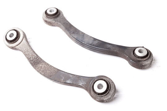 A pair of aluminum levers of the car chassis on a white isolated background in a photo studio, a spare part for replacement during car repair or for sale at an auto-parsing.